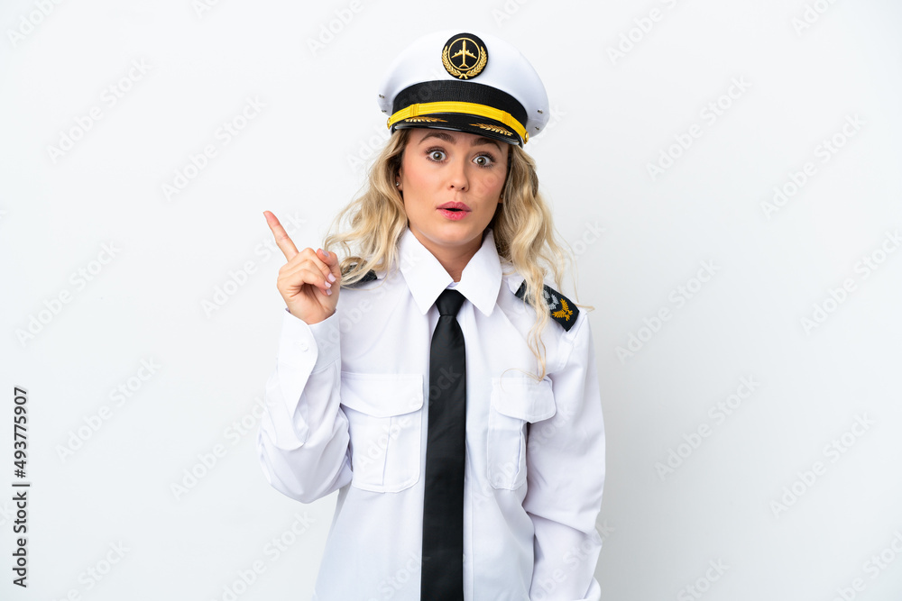 Airplane Brazilian pilot isolated on white background intending to realizes the solution while lifting a finger up Airplane Brazilian pilot isolated on white background intending to realizes the solution while lifting a finger up
