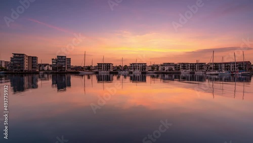 A colourful sunset at the marina with the new residential building in Nyborg on the island of Funen in Denmark photo