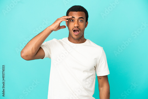 African American handsome man on isolated blue background has realized something and intending the solution