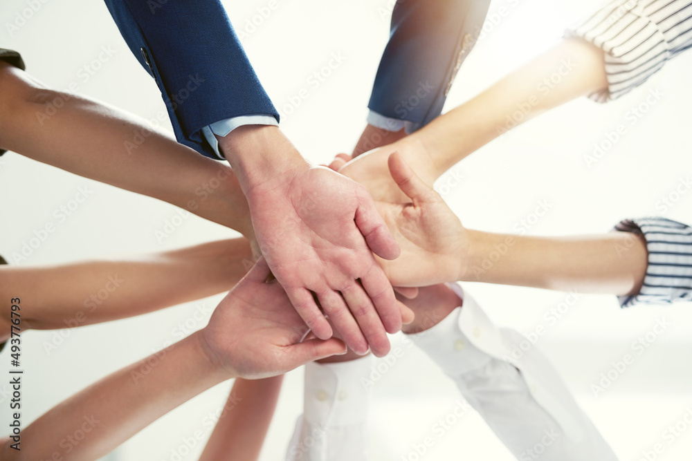 Well conquer together. Closeup shot of a group of businesspeople joining their hands together in unity. Well conquer together. Closeup shot of a group of businesspeople joining their hands together in unity.