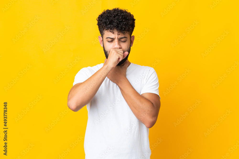 Young Moroccan man isolated on yellow background coughing a lot Young Moroccan man isolated on yellow background coughing a lot