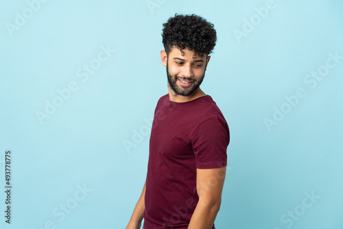 Young Moroccan man isolated on blue background . Portrait