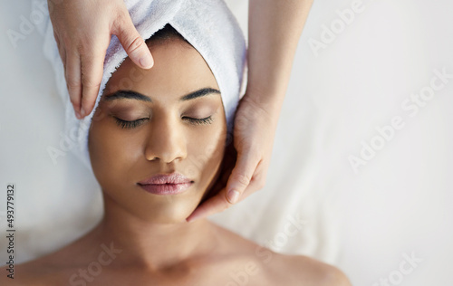 Keep on keeping calm. Shot of a young woman getting a facial treatment at a spa.