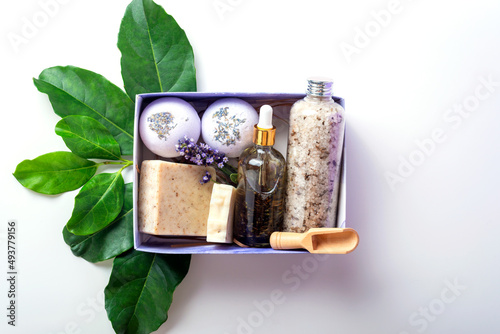 Lavender pamper gift box on green leaves as a concept of natural cosmetic and spa products.