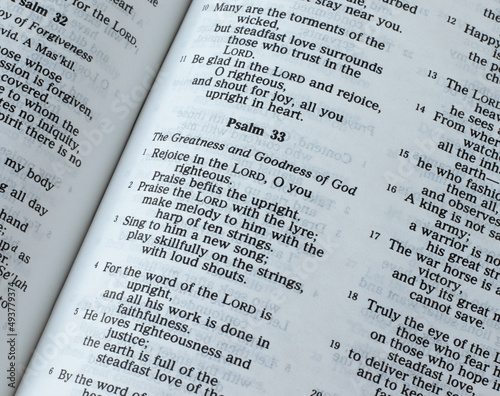 Psalm 33, greatness and goodness of God Jesus Christ, Old Testament Scripture. An open Holy Bible Book. A closeup. The Christian biblical concept of love, faith, and hope in the LORD.