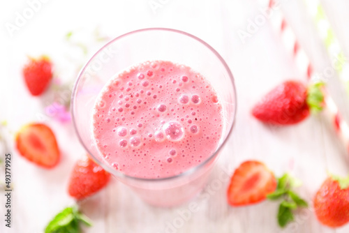 strawberry smoothie in glass with strawberries