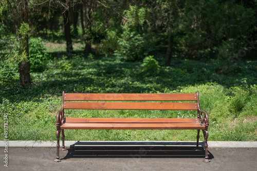 Orange wooden bench in the city park.