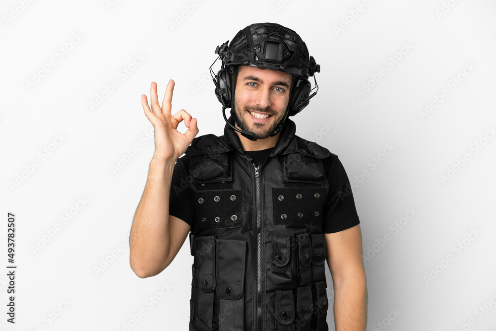 Young caucasian swat isolated on white background showing ok sign with fingers Young caucasian swat isolated on white background showing ok sign with fingers