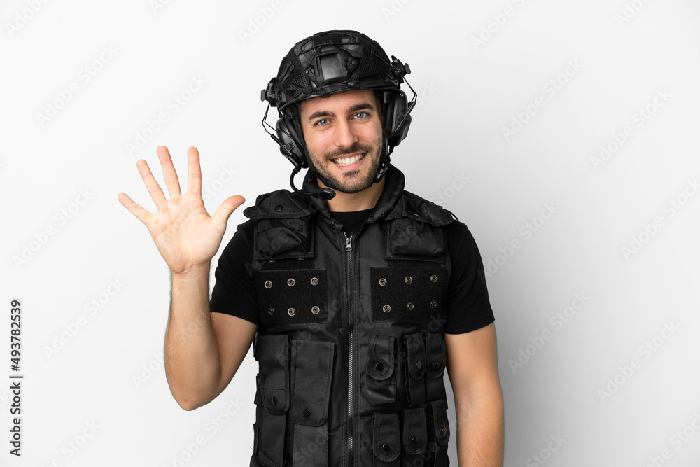 Young caucasian swat isolated on white background counting five with fingers Young caucasian swat isolated on white background counting five with fingers