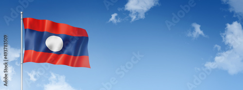 Laos flag isolated on a blue sky. Horizontal banner