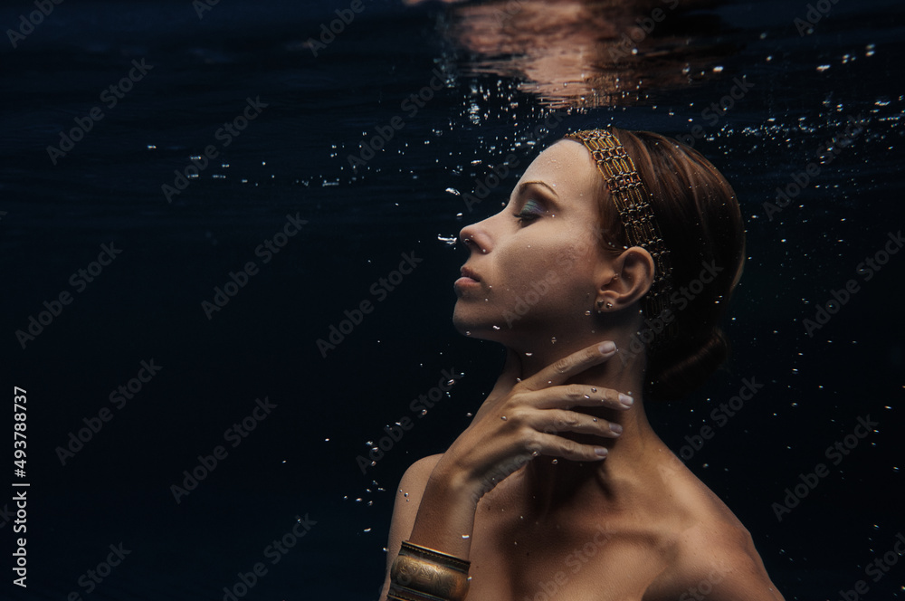 Mermaid. Portrait of young beautiful woman underwater.