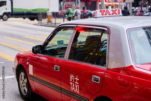 Photography Red cab taxi in a street downtown in Central Hong Kong.