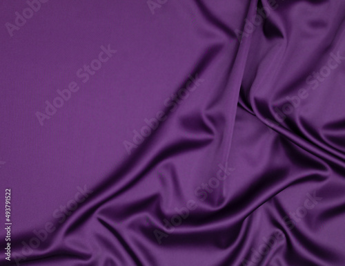 Abstract background with copy space - purple fabric with folds.