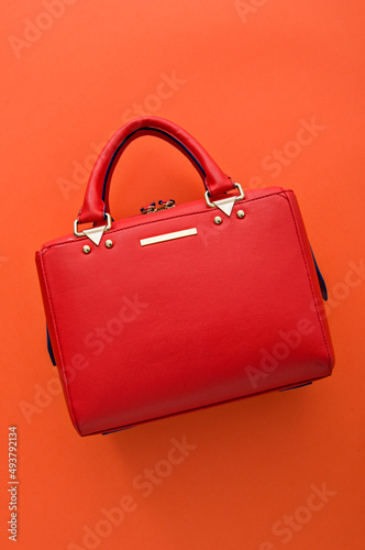 Red handbag on an orange background, Stylish side bag, Leather bag, orange background, Minimalism