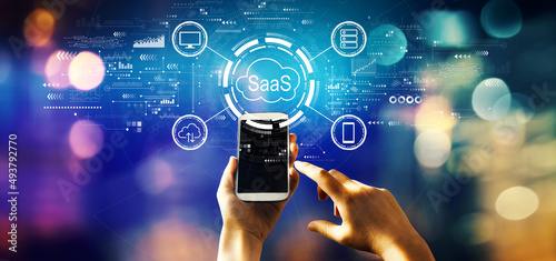 SaaS - software as a service concept with person using a smartphone photo