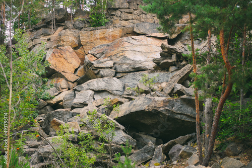 Stone rocks. Large stones in a coniferous forest. Granite quarry. Abandoned industrial production.