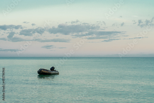 Fototapeta Naklejka Na Ścianę i Meble -  Life boat with out people alone in the sea on sunset time