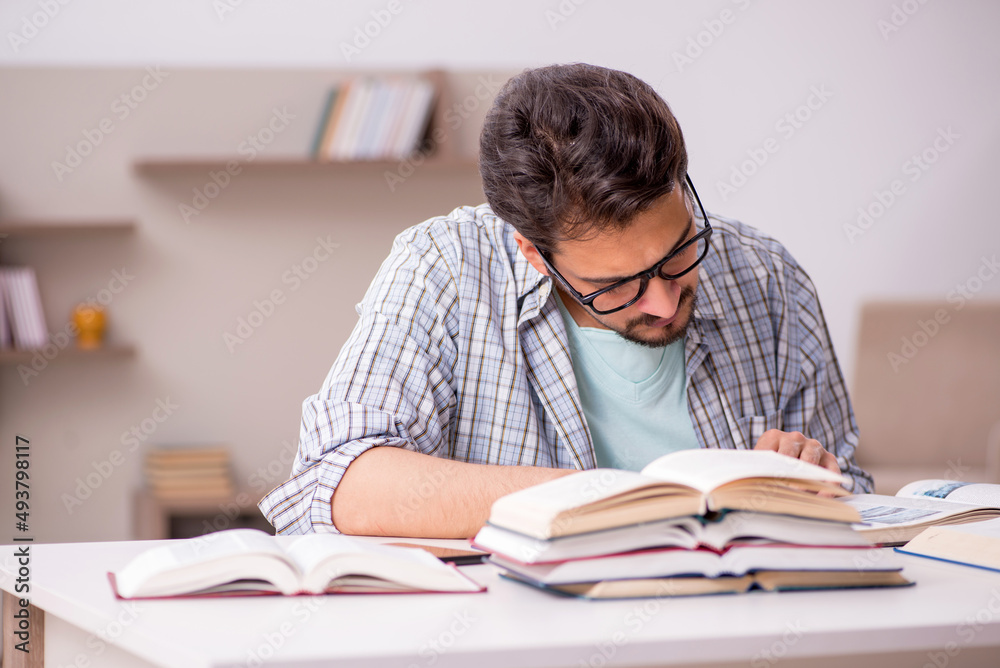 Young male student preparing for exams at home Young male student preparing for exams at home
