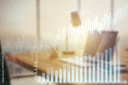 Double exposure of abstract creative financial chart on modern laptop background  research and strategy concept