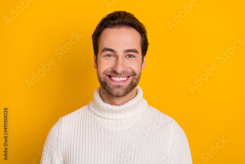 Photo of cheerful bearded guy shiny beaming smile wear white pullover isolated yellow color background