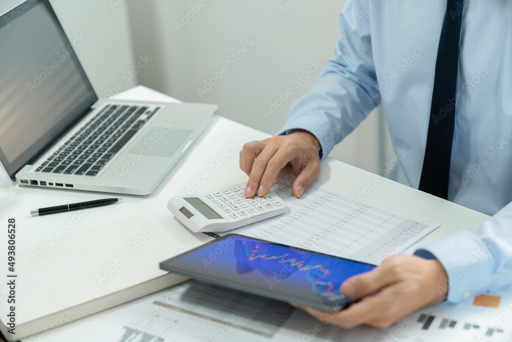 Business investor executive using laptop analyzing value of stock market exchange. Investment planing