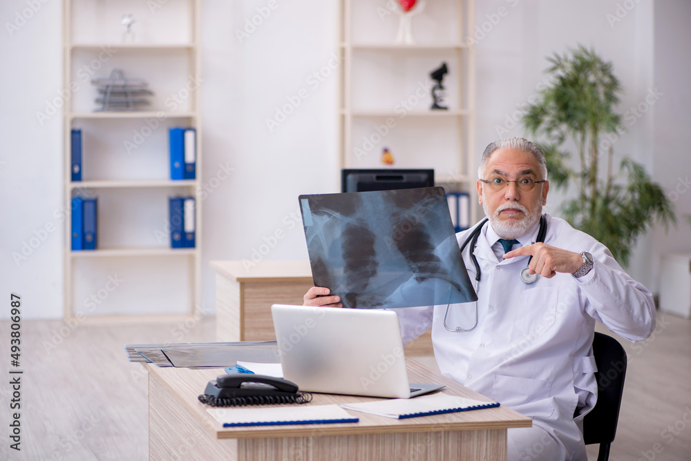 Old male doctor radiologist working in the clinic Old male doctor radiologist working in the clinic