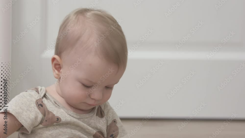Toddler playing with electric wire on floor at living room, 1 year old infant holding the electric cord of air purifier, risky objects around the house for baby. High quality 4k footage Toddler playing with electric wire on floor at living room, 1 year old infant holding the electric cord of air purifier, risky objects around the house for baby. High quality 4k footage