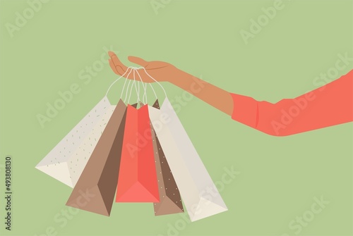 A woman's hand holding shopping bags