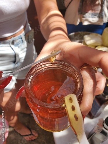 hands holding a jar of honey 