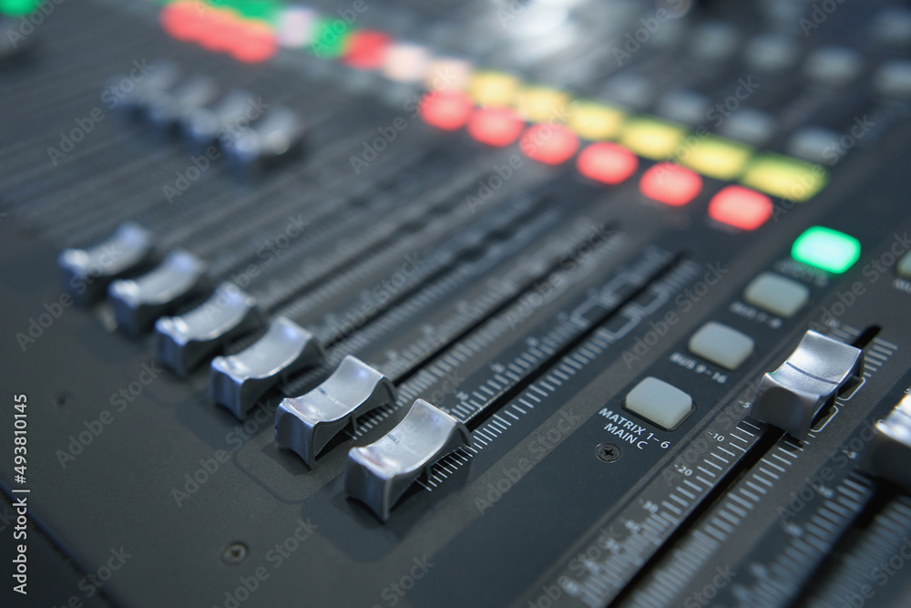 Professional audio mixing console. ​Mixer. Pro audio mixing board faders and knobs. Static shot of multi-track music recording equipment faders and sliders. 