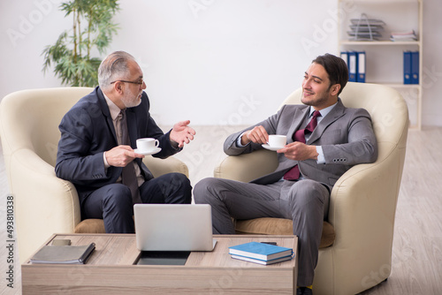 Two businessmen discussing project at workplace