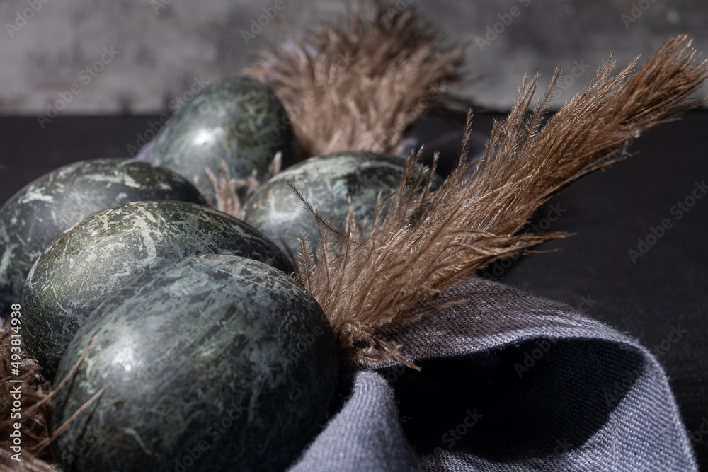 Fototapeta premium Gray easter eggs on black background