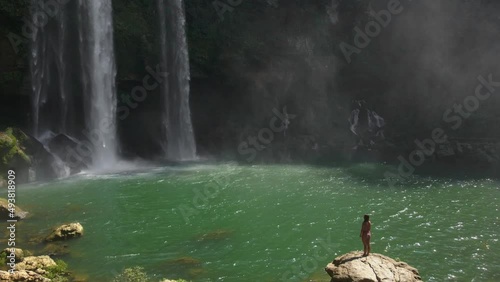 Female Tourist Enjoing the View of Misoh-Ha Waterfall in Chiapas, Mexico photo