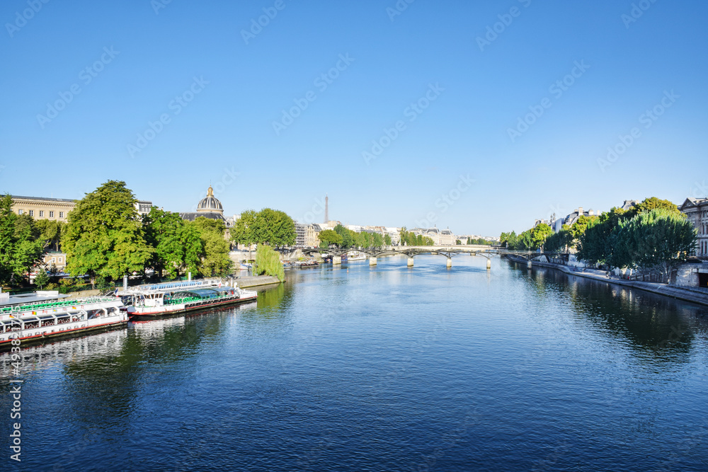Beautiful panoramic view from the Seine River to the bridge and the city landscape on a sunny summer day. Paris, France