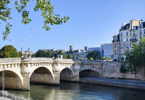 Beautiful panoramic view from the Seine River to the bridge and the city landscape on a sunny summer day. Paris, France