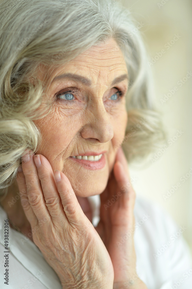 Beautiful smiling senior woman posing at home Beautiful smiling senior woman posing at home