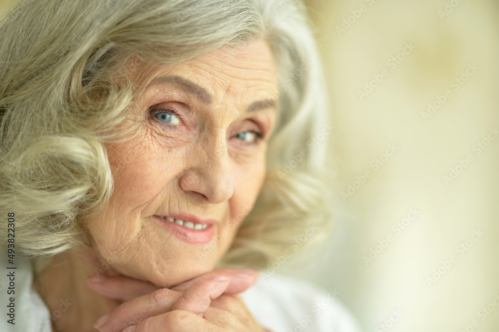 Beautiful smiling senior woman posing at home Beautiful smiling senior woman posing at home