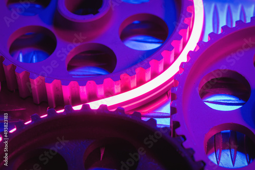 Canvas Print Old car gear wheels in the neon lights abstract close up background