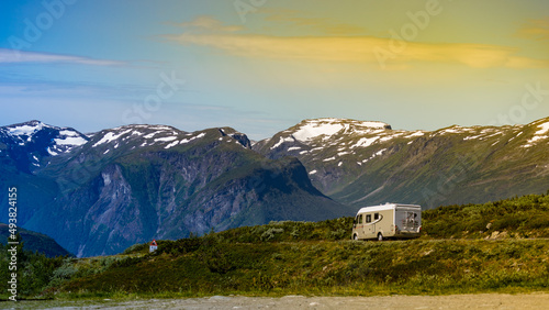 Camper car on road in norwegian mountains photo