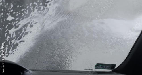 Auto detailer washes the car by foam from non-contact high pressure washer , 4k 60p Prores