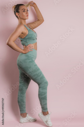 Fitness sporty woman during exercises workout. Beautiful fit Girl in sport wear. Fitness model backdrop. Weight Loss. Healthy lifestyle. Sporty healthy female. © Jan