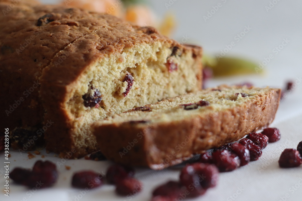 Sliced Orange cranberry bread loaf. An orange flavoured quick bread with dried cranberries. A perfect accompaniment to coffee.