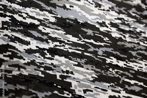 Fabric with texture of Ukrainian military pixeled camouflage. Cloth with camo pattern in grey, brown and green pixel shapes. Official uniform of Ukrainian soldiers photo