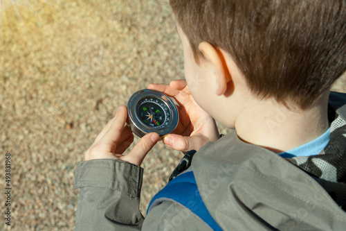child Tourist holding compass in hand, Brass antique classical compass