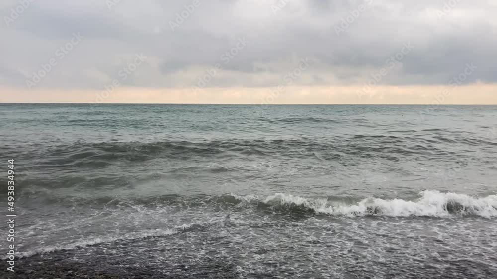 Sea waves against a cloudy sky Sea waves against a cloudy sky