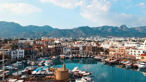 Aerial 4k Historical Kyrenia Harbour with medieval Venetian Castle is located next to the sea in Mediterranean Island of Cyprus which is located coastal city Kyrenia in North Cyprus photo