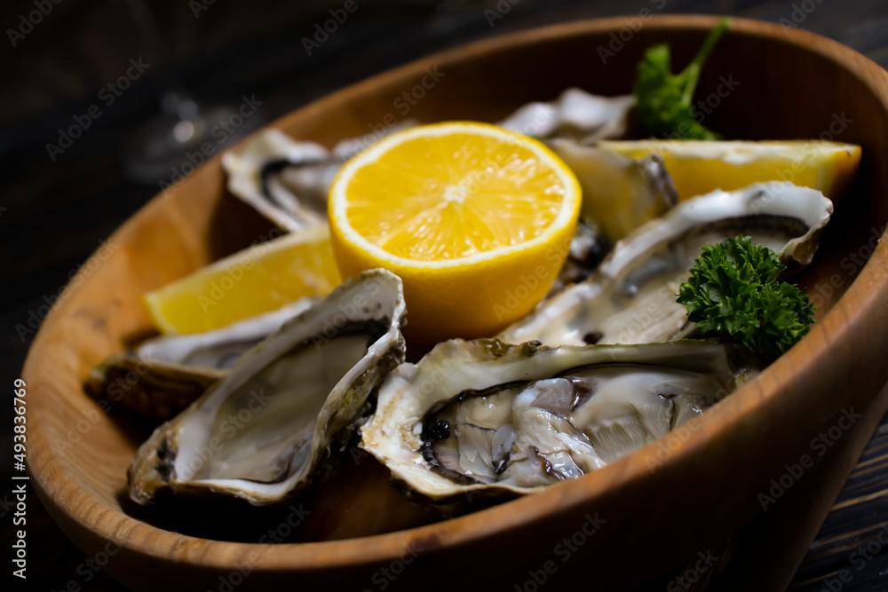 fresh oysters, lemon on wooden background fresh oysters, lemon on wooden background