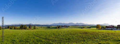 Idyllic farmland landscape in the Alps, fresh green agricultural land with mountain in background, Allgäu, Bavaria, Seeg, panorama