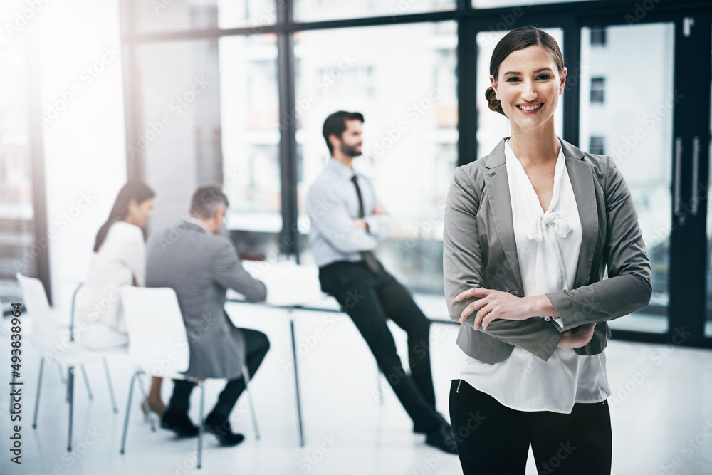 Teamwork and success go hand in hand. Portrait of an attractive young businesswoman standing in the boardroom during a meeting. Teamwork and success go hand in hand. Portrait of an attractive young businesswoman standing in the boardroom during a meeting.