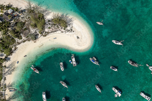 Drone aerial view of anchored sailing yacht in emerald Caribbean sea, Stocking Island, Great Exuma, Bahamas. photo